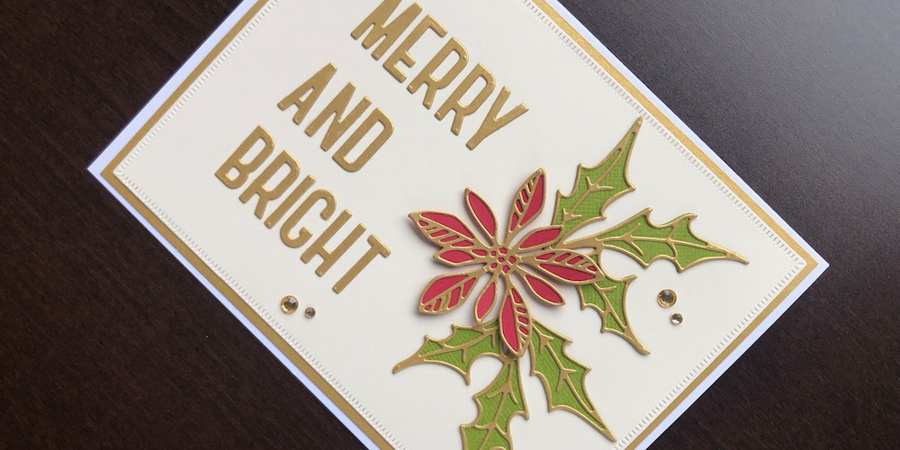 Hand made Christmas card with die cut poinsettia, holly and Merry and Bright sentiment