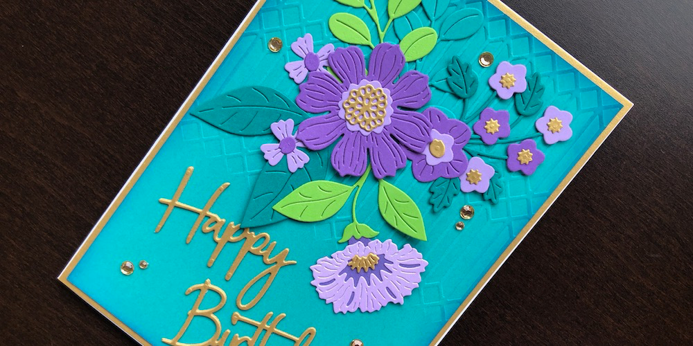 Hand made birthday card with die cut flowers and partial embossing